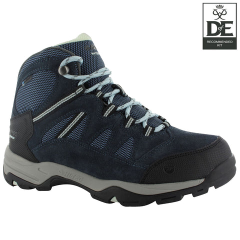 A dark blue hiking boot sits upright featuring mesh and suede materials with laces threaded through metal hooks providing support situated against a white background displaying a logo in the corner.