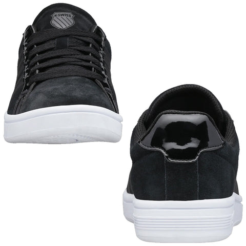Black athletic shoes are displayed from the front and back showcasing a suede upper and rubber white sole with laces and a sleek design suitable for casual wear.