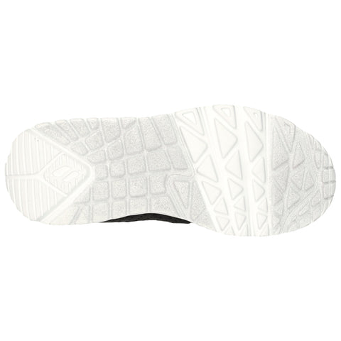 A shoe sole features a textured black upper portion and a white rubber bottom designed for traction and stability. The context suggests it is suitable for athletic or casual use.