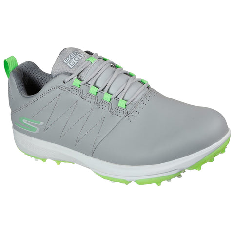 A gray golf shoe with green accents has a rounded toe and a cushioned interior. It features a laced design and a cleated sole for traction on the golf course.