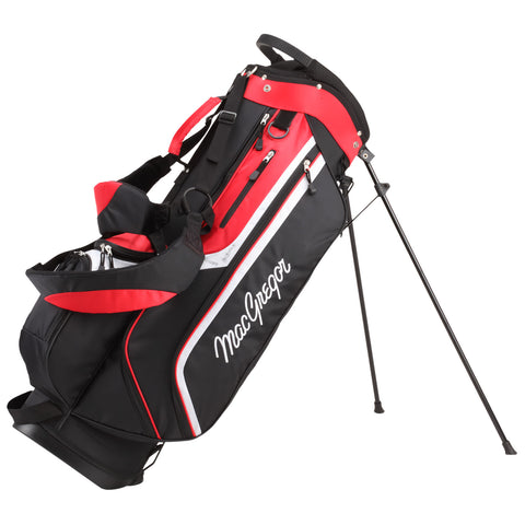 A black and red golf bag stands upright on a tripod-like stand showcasing multiple compartments and zippers designed for carrying golf clubs and accessories in an outdoor golfing environment.