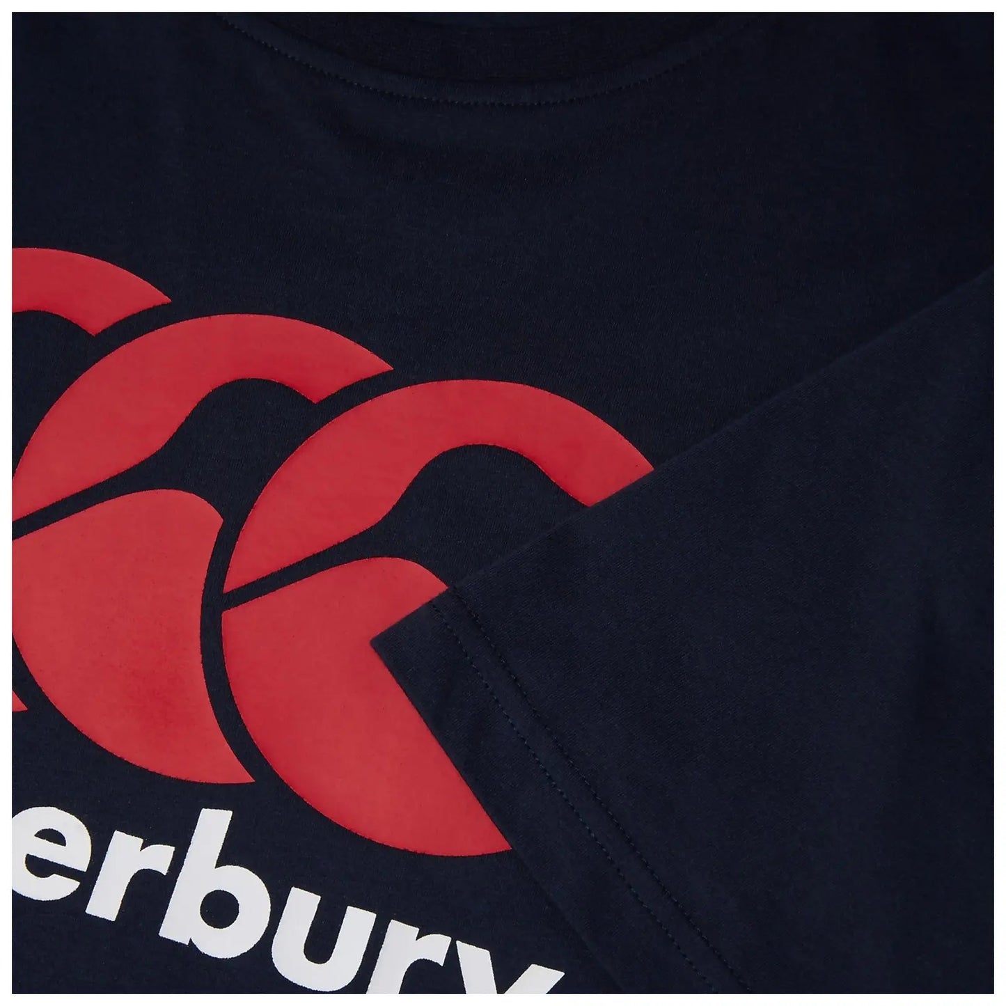 A navy blue t-shirt features a large red overlapping logo and the word Canterbury below the logo with a sleeve partially visible in the frame.