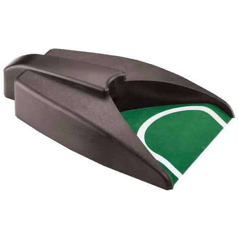 A black device with a curved top and a green mat featuring a white shape is designed to assist in a specific activity likely related to sports or games, placed on a flat surface.
