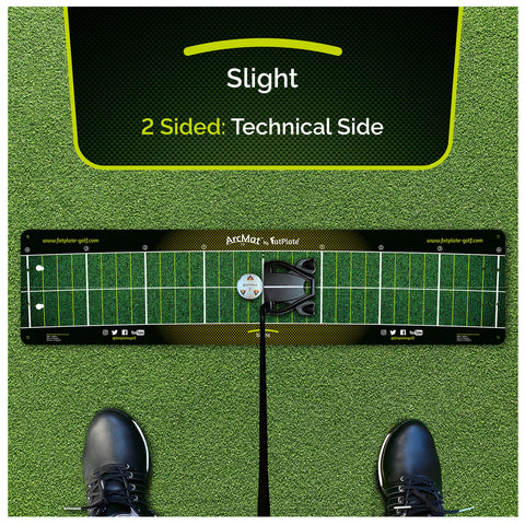 A golf training mat lies on green turf designed for practice with a black shoe positioned nearby on the mat displaying alignment guides and a central marker for putting technique. Text includes "Slight" "2 Sided: Technical Side" and website information