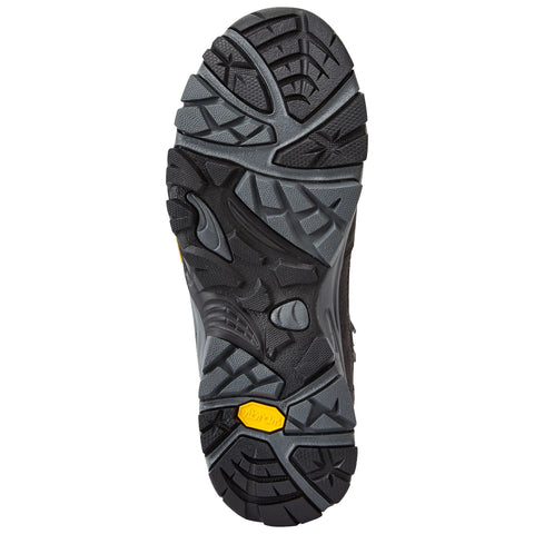 A rugged shoe sole with a textured surface designed for grip facing downwards showcasing various tread patterns and a yellow vibram branding element for enhanced traction on various terrains