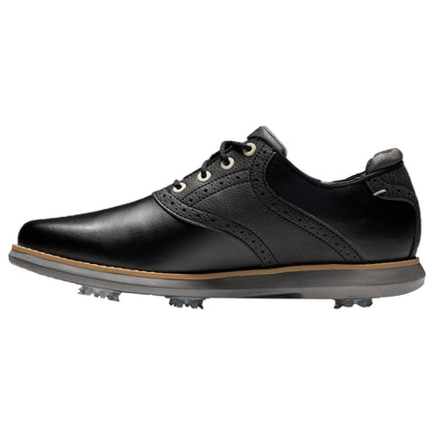A black golf shoe features a sleek design with layered materials and decorative perforations. It is positioned on a white background, highlighting its cleated sole and contrasting colors.