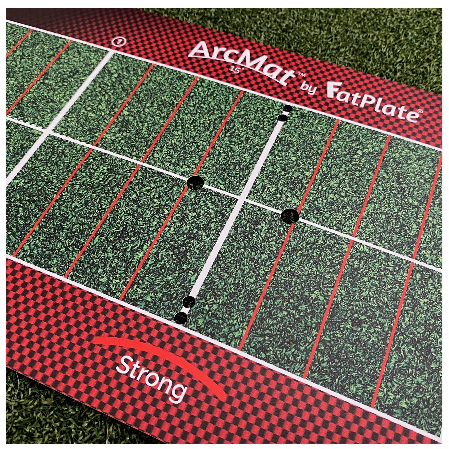 A green and red patterned training mat labeled ArcMat by FatPlate is displayed with markings creating sections and holes on a textured surface resembling grass.