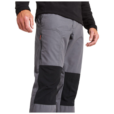 Gray pants with black knee patches are being worn by a person with a hand slightly raised. The person is dressed in a black long-sleeve shirt and appears to be in a neutral indoor setting.
