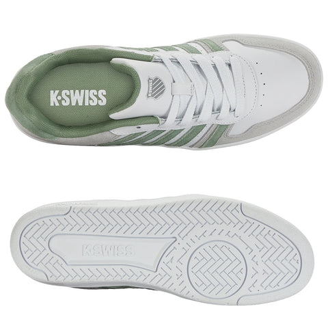 Sport shoe with a white leather upper featuring teal suede accents and three striped designs on the side positioned against a neutral background highlighting its athletic style