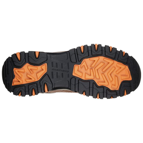 A brown and gray sneaker with black laces is displayed from above. The shoe features a mesh and suede exterior with a red cushioned interior and a sturdy sole. A shoe sole is displayed with a rugged design featuring deep treads in black and orange The textured surface suggests durability and traction suitable for various terrains