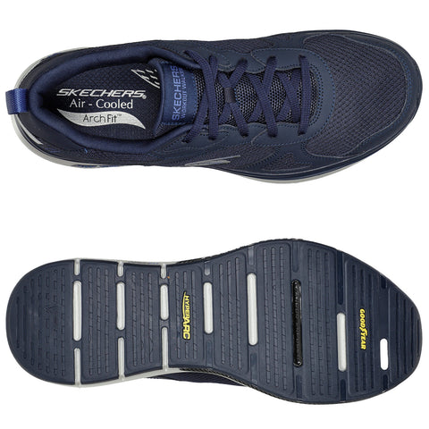 A navy sneaker is displayed with a breathable mesh upper and a cushioned sole featuring grooves for traction resting on a neutral background showcasing its details and branding.
