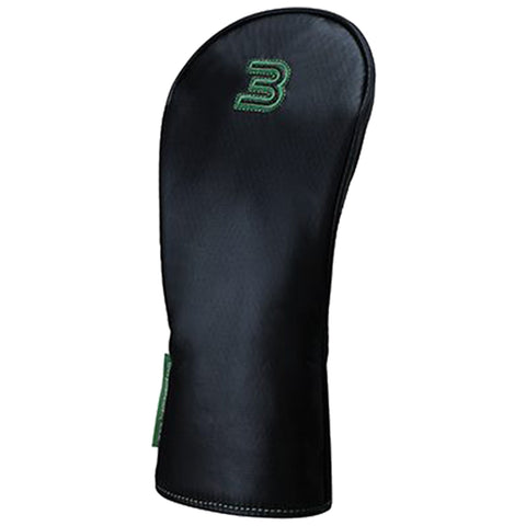 A black golf club headcover stands upright featuring a distinctive green logo on the front designed to protect the club head from damage and dirt on the golf course.