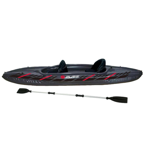 A black inflatable kayak with red accents sits on a flat surface with two seats visible and a paddle lying beside it, ready for water exploration.