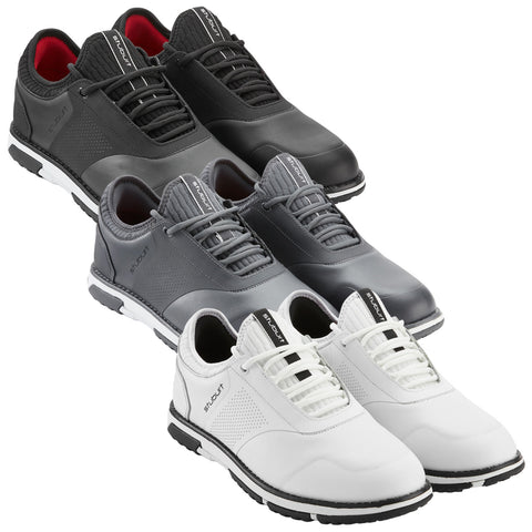 Three pairs of golf shoes are arranged in a stack featuring black grey and white designs with slender laces and textured materials on a white background.