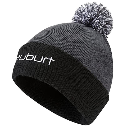 A gray knitted beanie hat with a black brim features a white logo and a fluffy pom-pom on top designed for warmth in cold weather settings.