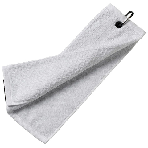 A white towel is hanging loosely and is slightly folded with a metal clip attached to one end resting against a flat surface providing a clean and functional appearance.