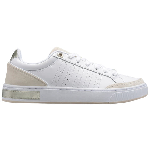 A white sneaker with a smooth leather body features a light beige suede heel and side accents while laces secure the front in a casual design suitable for everyday wear.