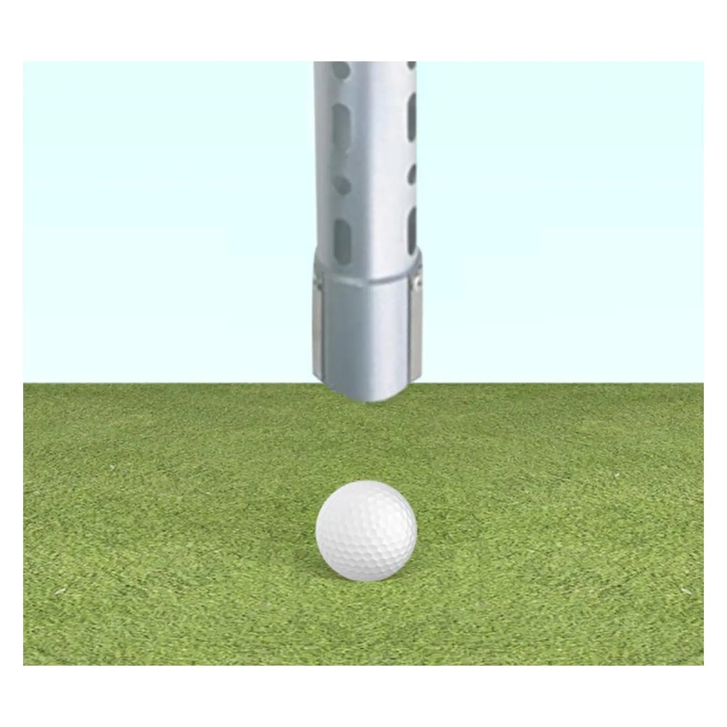 A metallic golf club head is positioned just above a white golf ball resting on a green turf surface under a light blue sky indicating preparation for a swing or strike.