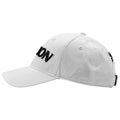 A white baseball cap displays the word "DION" in bold black letters on the front while resting flat on a surface emphasizing its casual design in a plain background.