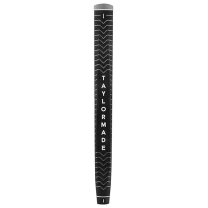 A black golf club grip with a textured surface features the brand name TAYLORMADE printed in white letters along the length while the grip is positioned upright against a plain background.