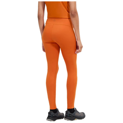 Black leggings are displayed upright showcasing their full length featuring a wide waistband and minimal stitching details in a plain background suggesting a clothing retail context.