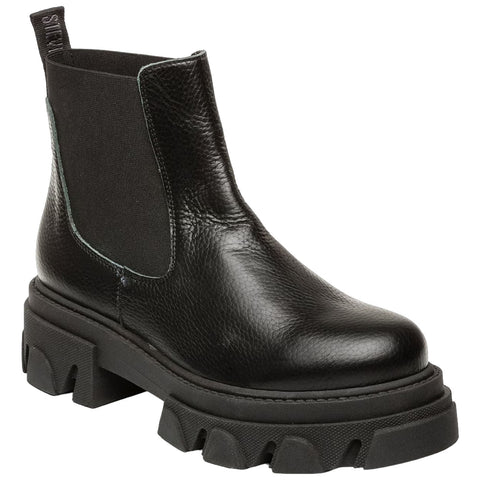 A black leather ankle boot features elastic side panels and a thick, chunky sole with a wavy design showcasing a modern style suitable for casual or edgy outfits.
