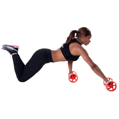 A woman in athletic wear performs a push-up variation using red wheel weights on a plain white background, focusing on strength training and core stability.