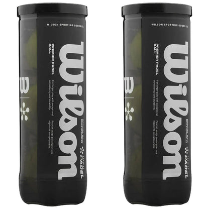 Two cylindrical containers are displayed upright containing padel balls The containers are black with white text that reads Wilson Premier Padel with additional descriptive text on durability and usage