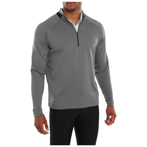 A gray long-sleeve pullover with a half-zip is worn by a man. He stands with his left arm slightly raised in a neutral background.