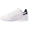 A white sneaker with a sleek design features a smooth leather exterior and a navy blue accent on the heel it is positioned to showcase its profile against a plain background