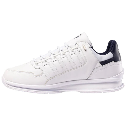 A white sneaker with a sleek design features a smooth leather exterior and a navy blue accent on the heel it is positioned to showcase its profile against a plain background
