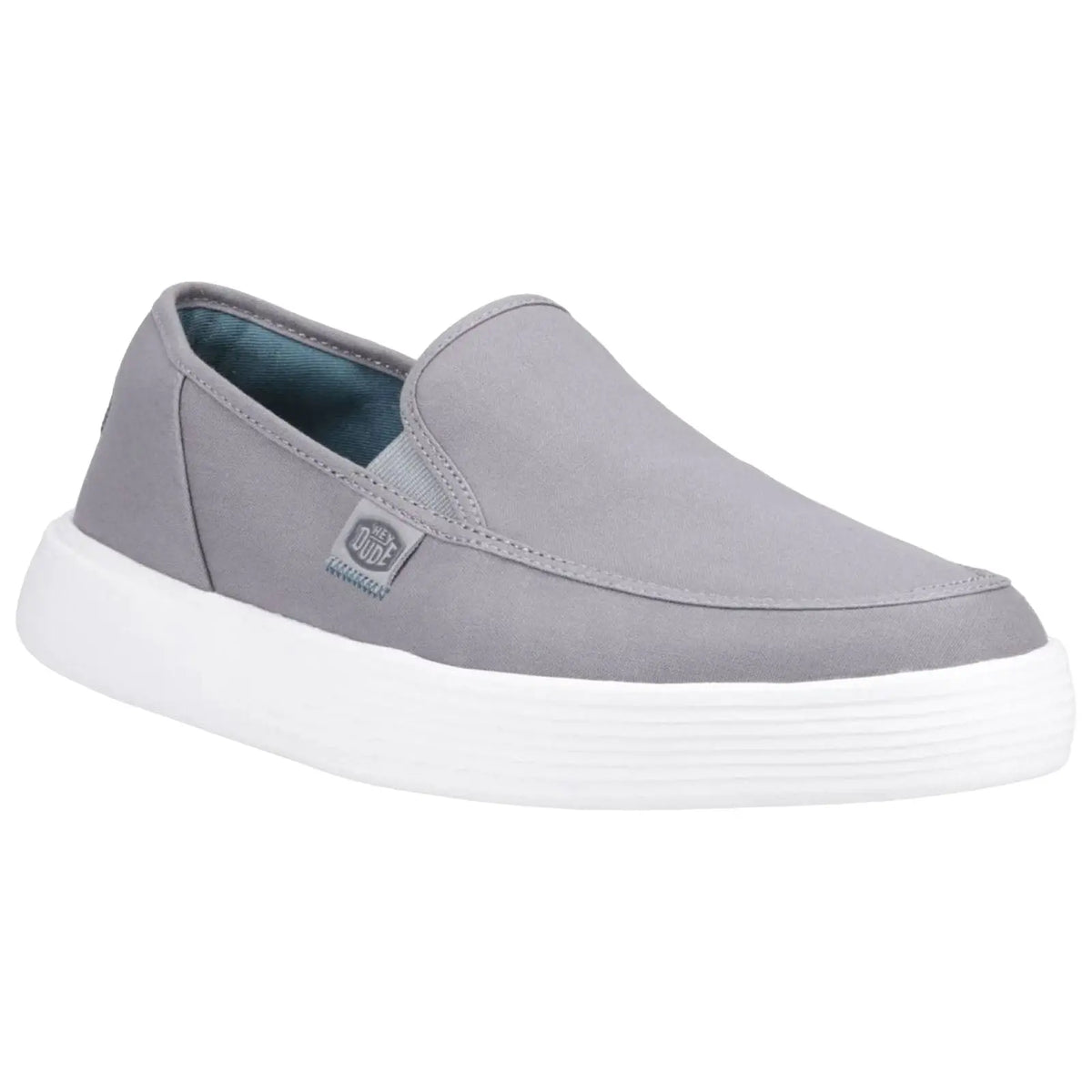 A gray slip-on shoe with a smooth fabric upper features a white rubber sole and a small brand tag on the side displayed on a plain white background.
