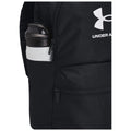 A black backpack features a side pocket holding a white water bottle with a dark cap showcasing the Under Armour logo the backpack is designed for sporty use and convenience.