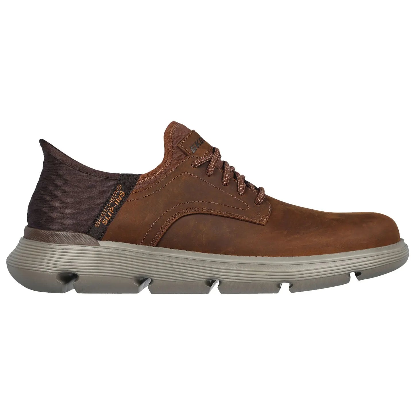 A brown leather shoe with a textured dark heel and a light gray sole is displayed sideways showcasing its laces and sleek design emphasizing a casual yet stylish appearance.