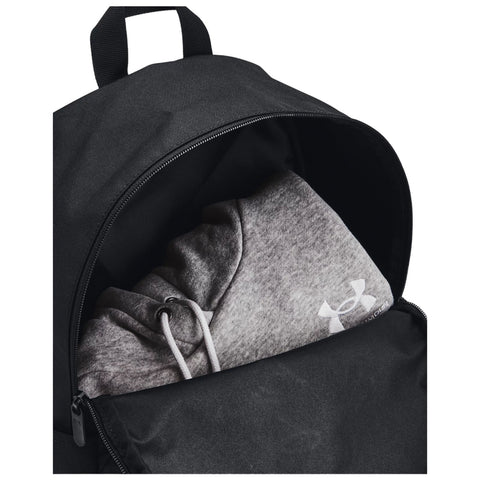 A black backpack contains a gray hooded sweatshirt visible at the opening the sweatshirt has drawstrings and a logo on the sleeve indicating its brand.