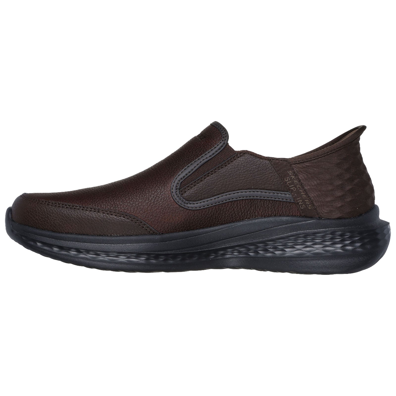A brown slip-on shoe is displayed from the side resting on a flat surface featuring textured leather and a cushioned sole designed for comfort and ease of wear.