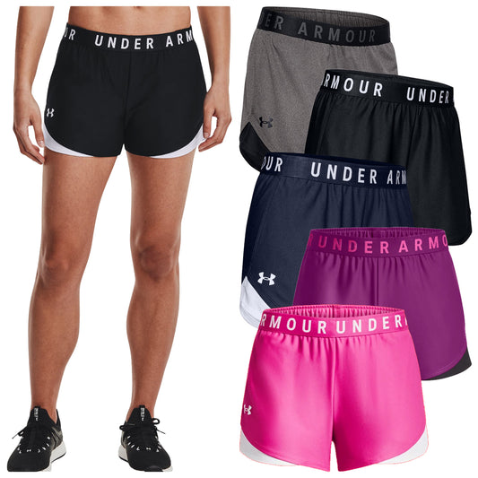 Athletic shorts in various colors are displayed alongside a model wearing a black pair. The shorts feature an elastic waistband and the brand name 'UNDER ARMOUR' prominently on the waistbands.
