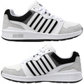 White athletic shoes feature black and gray accents with a mesh material and suede details. They are positioned to highlight both sides for a detailed view of the design.