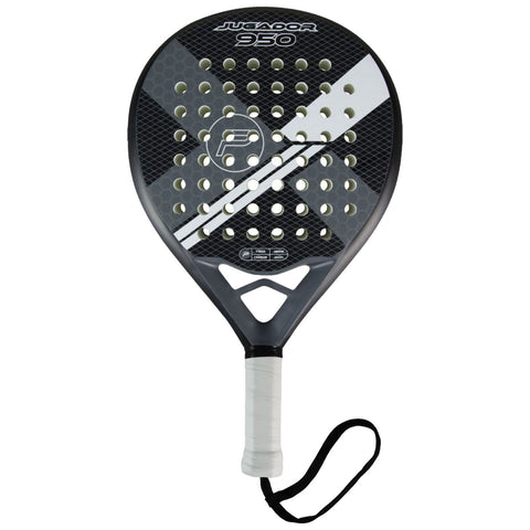 A padel racket features a perforated head with a black and white design and a textured grip handle with a wrist strap while resting on a flat surface.