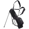 A black and white golf bag stands upright with extending legs and shoulder straps designed for carrying. It features multiple zippered pockets and a prominent brand name on the side.