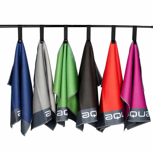 Six different colored towels hang on a horizontal rod. They are arranged in a sequence from blue to pink with a textured fabric and a logo at the bottom of each towel.
