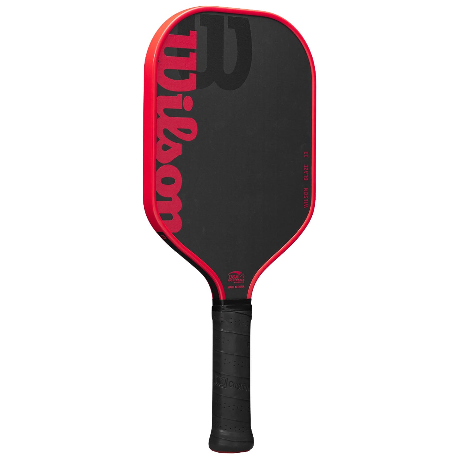 A paddle with a black textured surface features a red border and the brand name Wilson prominently displayed. The handle has a rubber grip, suitable for racket sports.