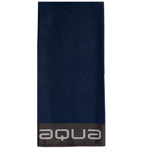 A rectangular dark blue towel lies flat displaying a light gray brand name aqua at the bottom edge in a contrasting dark band suggesting use in aquatic settings like swimming or the beach