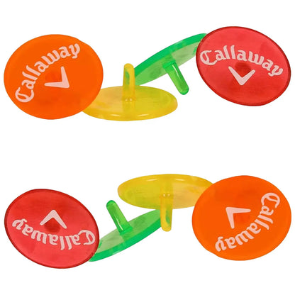 Colorful golf markers are arranged in pairs with visible branding. They are placed upright on a flat surface, suggesting use during a game or practice session.