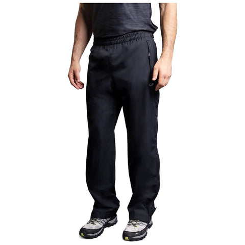 A person is standing wearing black pants and gray shoes with a patterned sole the environment is casual suggesting a relaxed outdoor or athletic setting