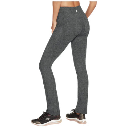 Leggings are being worn by a person facing away showcasing a high waistband and slim fit silhouette the setting suggests an active lifestyle with running shoes indicated