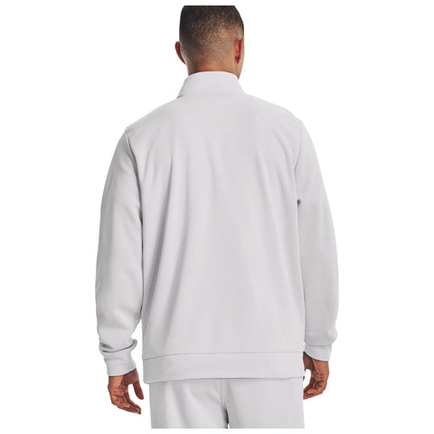 A person wearing a light gray zip-up jacket stands with their back to the viewer showcasing the jacket's design in a neutral background