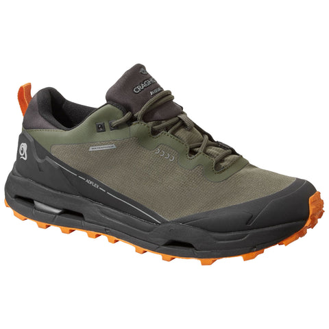 A green waterproof hiking shoe is displayed with a rubber sole featuring orange traction lugs designed for grip on rugged terrain suitable for outdoor activities