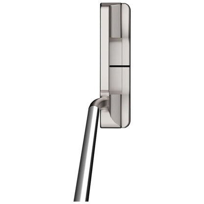 A sleek metallic object stands upright with a curved handle extending below it showcasing a modern design likely used for a specific functionality in a contemporary setting.