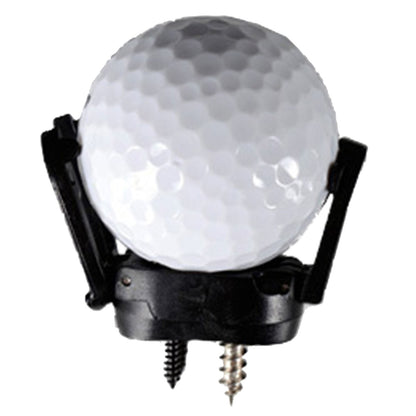 A white golf ball is secured in a black tee holder with two screws at the base. The setting appears to focus on golf equipment typically used on a course.